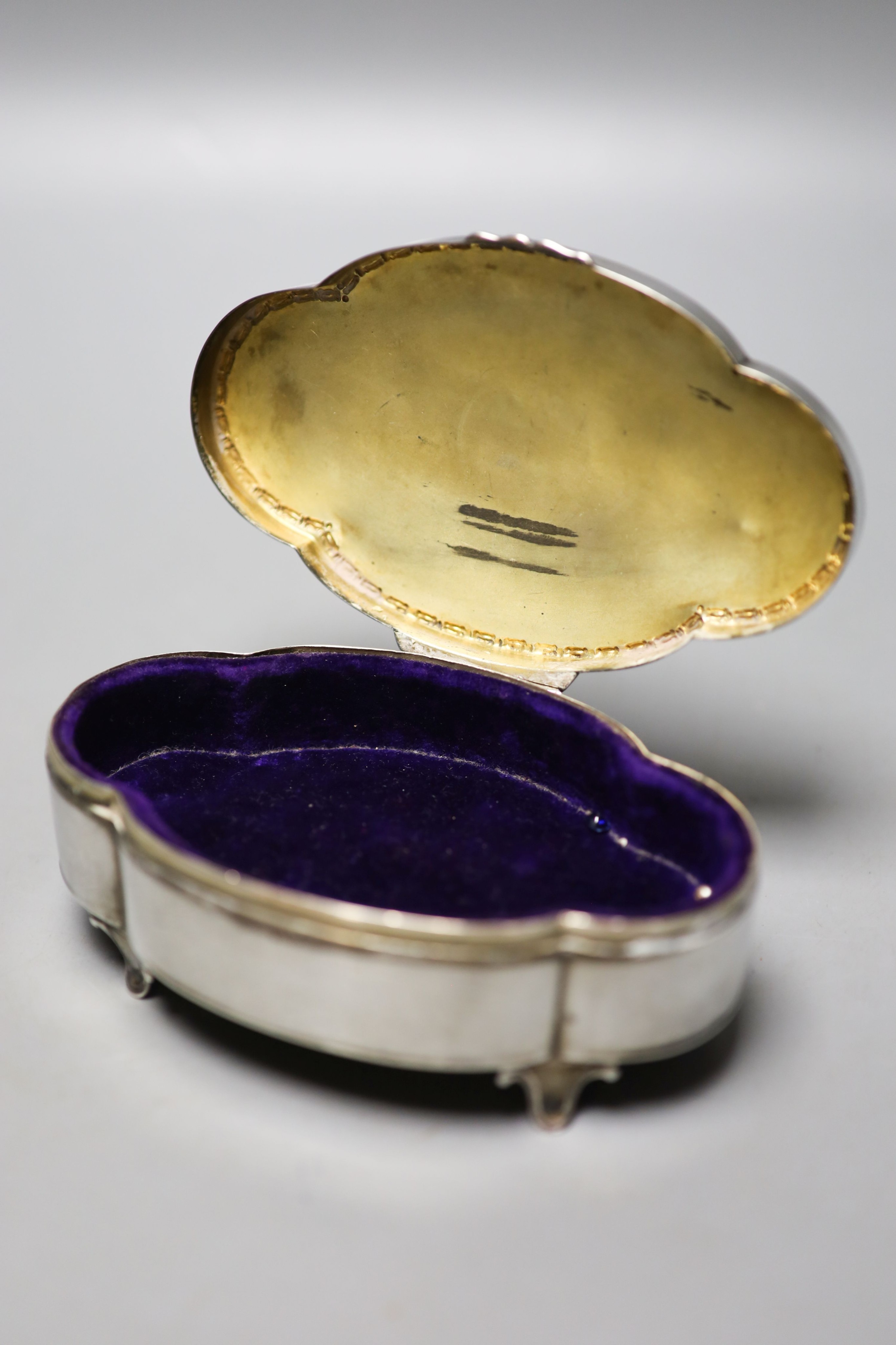 A George V part engine turned silver mounted shaped oval trinket box, Birmingham, 1911, 13.2cm.